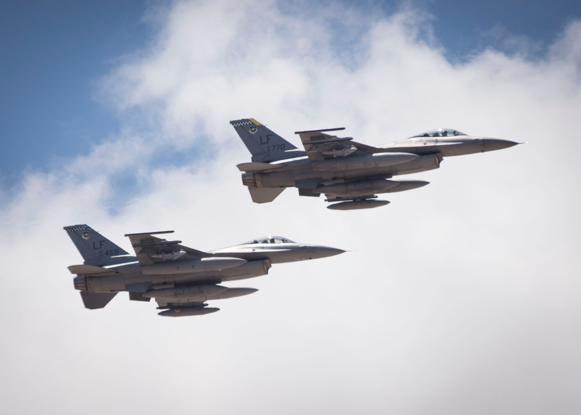 Two of the 12 F-16 Fighting Falcons departing from Luke Air Force Base, Ariz. arrive in formation and prepare to taxi toward their new homes at Holloman Air Force Base, N.M., June 16, 2015. The 54th Fighter Group will be activating the 314th Fighter Squadron with the twelve F-16s that have been transferred to Holloman. In March of 2014, the 54th Fighter Group was activated at Holloman. The 314th FS is the second squadron to transfer from Luke. (U.S. Air Force photo by Senior Airman Aaron Montoya / Released)