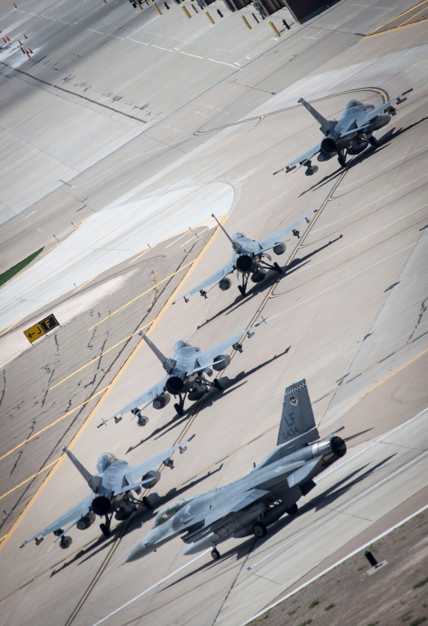 F-16 Fighting Falcons taxi toward their new hangars after being transferred as a new tenant unit to Holloman Air Force Base, N.M., June 16, 2015. The 54th Fighter Group will be activating the 314th Fighter Squadron with the 12 F-16s that have been transferred to Holloman. In March of 2014, the 54th Fighter Group was activated at Holloman. The 314th FS is the fourth squadron to transfer from Luke. (U.S. Air Force photo by Senior Airman Aaron Montoya / Released)