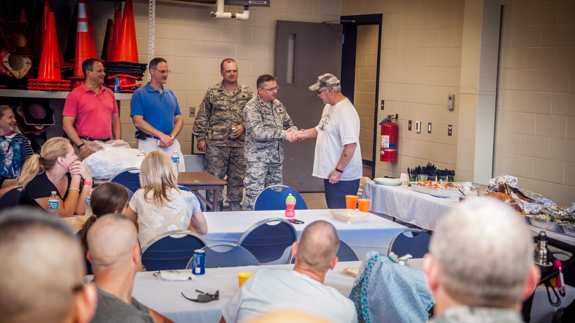 Maj. Greg Peterson, 934th Security Forces Squadron commander, thanks Steve Enebo, 1296th Everette McClay VFW Post commander, for his help providing food during a send-off for the soon to deploy 934 SFS Airmen and their friends and family.  (U.S. Air Force photo by Shannon McKay/Released)