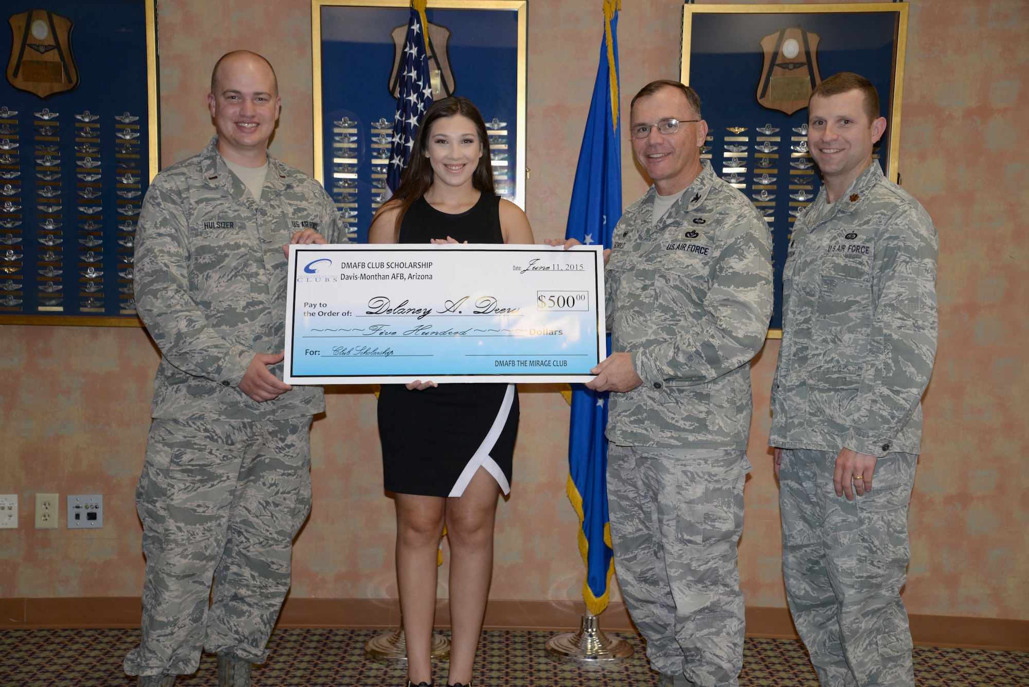 Delaney Alyssa Drew receives a check for $500 from the Air Force Clubs Scholarship Program by 2nd Lt. Charles Hulsizer, 355th Force Support Squadron career development chief, Col. Rodger Schuld, 355th Mission Support Squadron commander, and Maj. Stephen Anderson, 355th Force Support Squadron commander.  (Courtesy photo)