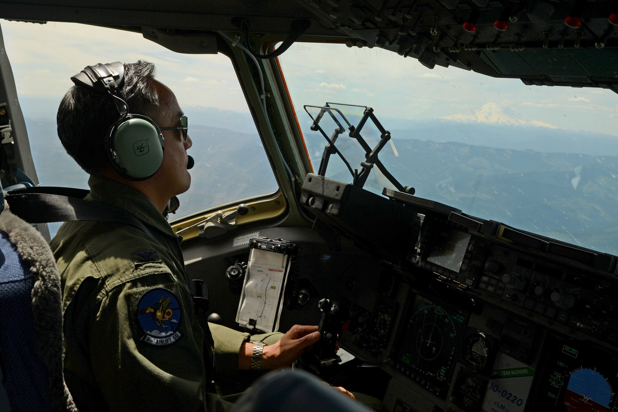 Col. David Kumashiro, 62nd Airlift Wing commander, flies a C-17 Globemaster III June 15, 2015, during his “fini flight” over central Washington state. While on his flight, Kumashiro performed touch-and-goes before landing at McChord Field. (U.S. Air Force photo by Staff Sgt. Tim Chacon)