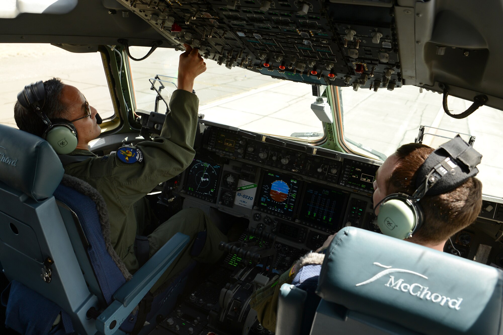 Col. David Kumashiro (left), 62nd Airlift Wing commander, prepares a C-17 Globemaster III before taking off June 15, 2015, over central Washington state. The flight was Kumashiro’s last flight as the wing commander. (U.S. Air Force photo by Staff Sgt. Tim Chacon)