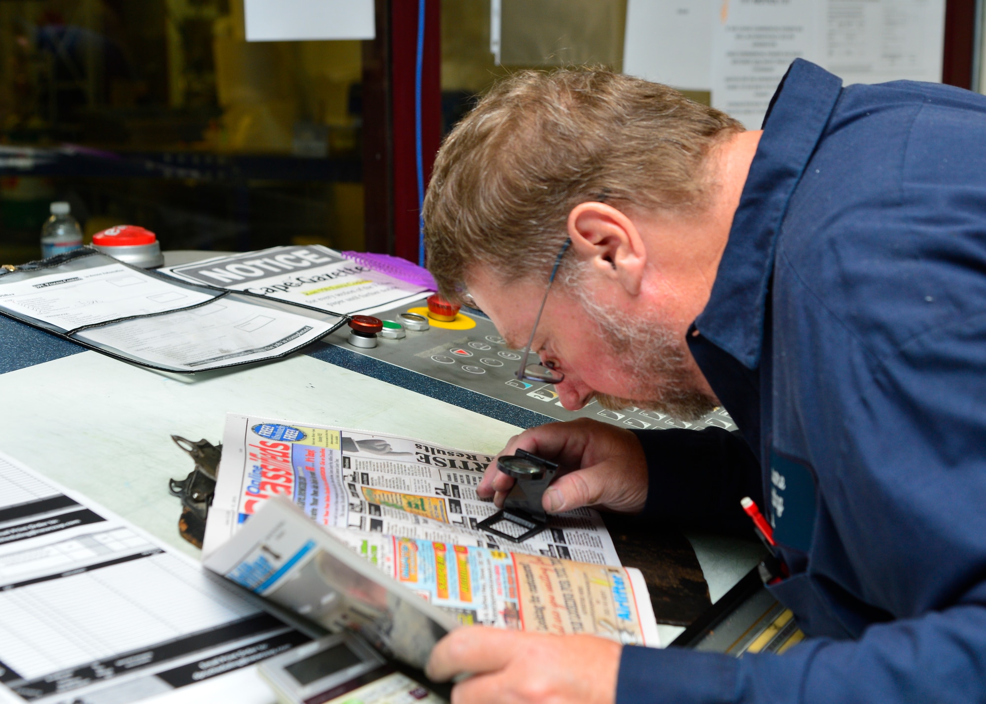 David Rehkamp, Delaware Printing Company pressroom manager, inspects a copy of the Airlifter to ensure the colors are aligned June 10, 2015, at Delaware Printing Company in Dover, Del. Rehkamp can make changes to the colors while the paper is printing if corrections need to be made. (U.S. Air Force photo/Airman 1st Class William Johnson)