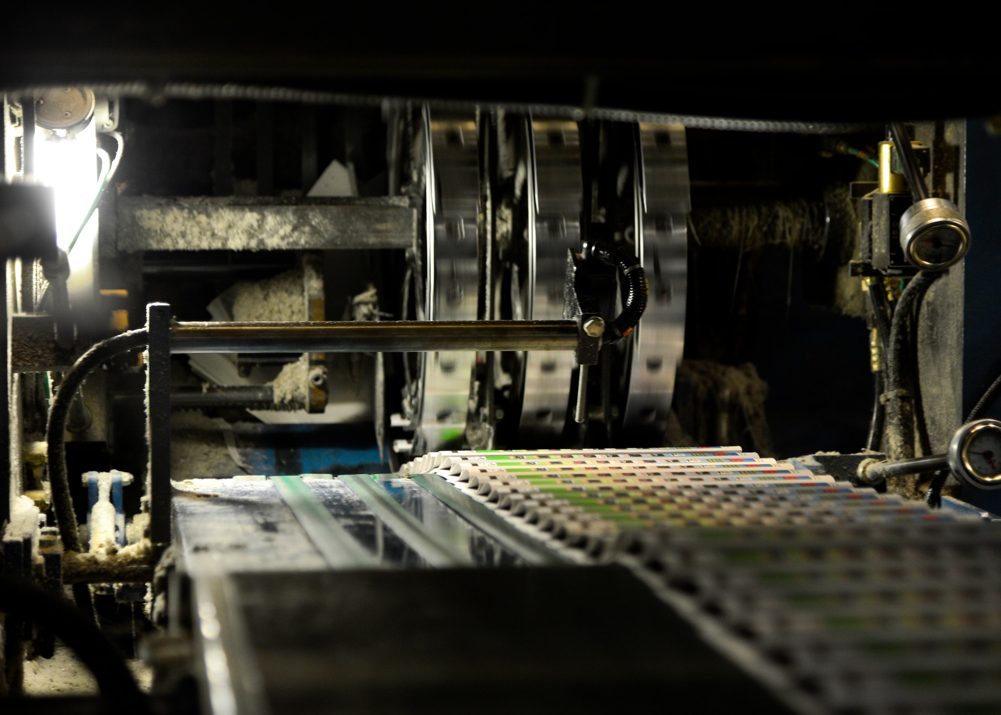 Copies of the Airlifter are cut and folded while exiting the printing press, June 10, 2015, at Delaware Printing Company in Dover, Del. The printing press prints 7,000 copies of the Airlifter each week. (U.S. Air Force photo/Airman 1st Class William Johnson)