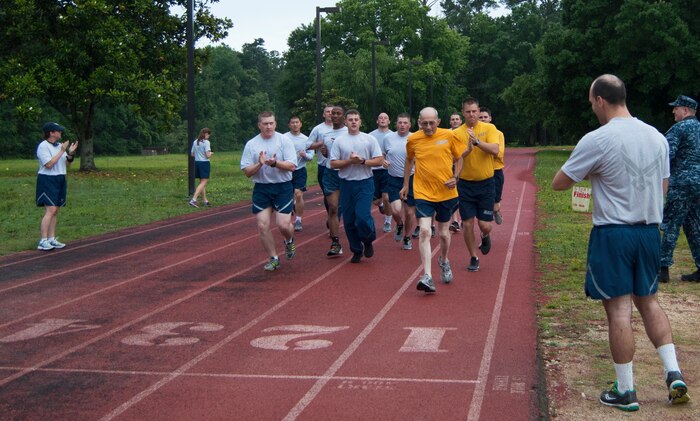 Master Chief Petty Officer (ret.) Sam Kirton about to cross the finish line after a 1.5 mile run as part of a combined Air Force/Navy PT test June 10, 2015 at Joint Base Charleston, S.C. At 76, Sam’s goal was to inspire Airmen and Sailors to be fit and always do their best. (U.S. Air Force photo / Senior Airman Sydney Manning) 