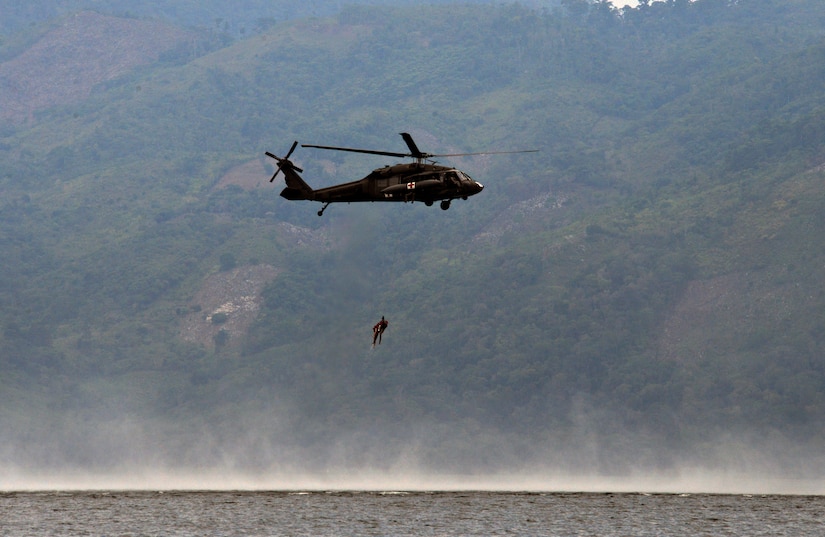 Members from the 1-228th Aviation Regiment Charlie Company practice overwater hoist training June 11, 2015, only one day prior to the rescue mission that saved a stranded American off the coast of Roatan. Training exercises such as the overwater hoist training ensure all 1-228th AVN REGT personnel are prepared to accomplish Joint Task Force – Bravo’s humanitarian missions at any given time. (U.S. Air Force photo by Staff Sgt. Jessica Condit)