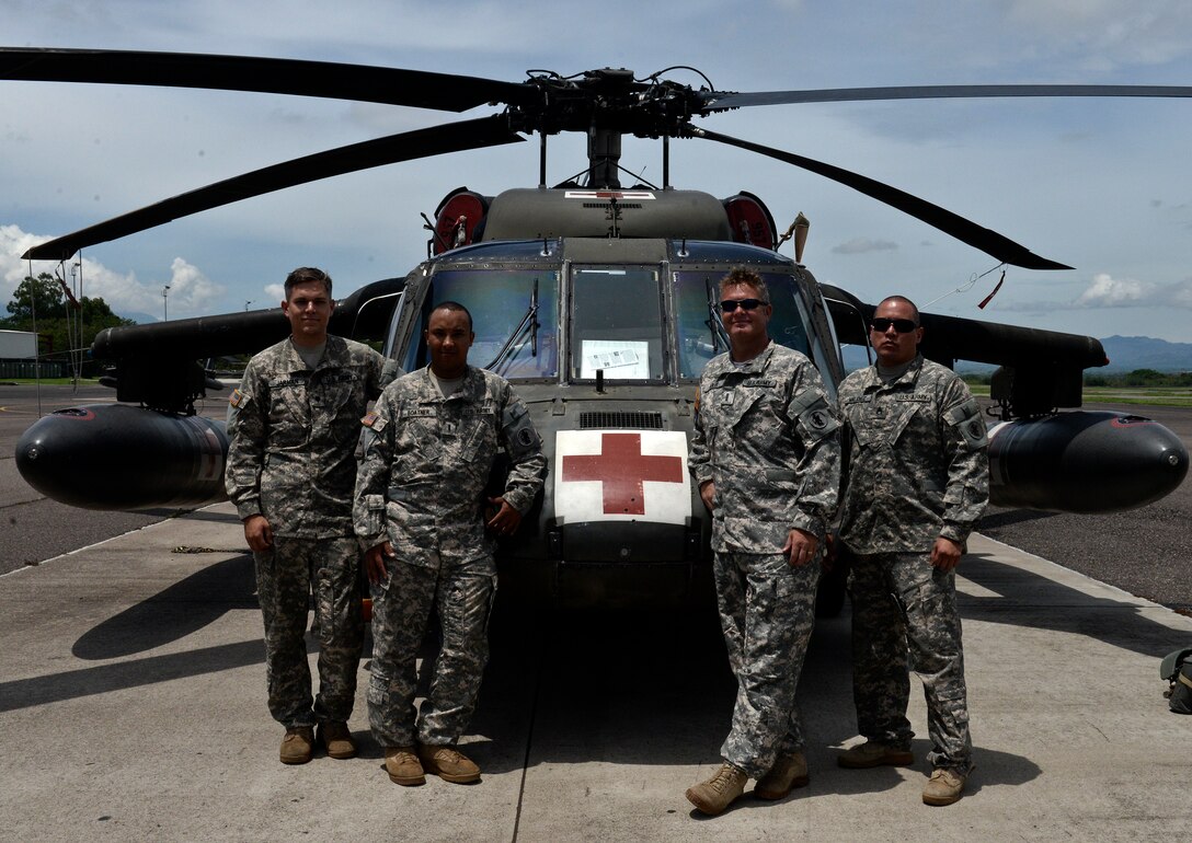 From left to right, Spc. Matthew Jarman, Chief Warrant Officer 2 Robert Boatner, Chief Warrant Officer 4 Erik Adler and Staff Sgt. Chris Valdez, a 1-228th Aviation Regiment Charlie Company crew, pose for a photo June 12, 2015, at Soto Cano Air Base, Honduras after returning from a mission to Roatan. The crew worked in conjunction with Honduran counterparts to rescue Aaron Rose, an American citizen stranded at sea. Rose was found more than 18 miles from the coast of Roatan, clinging to his overturned kayak. (U.S. Air Force photo by Staff Sgt. Jessica Condit)