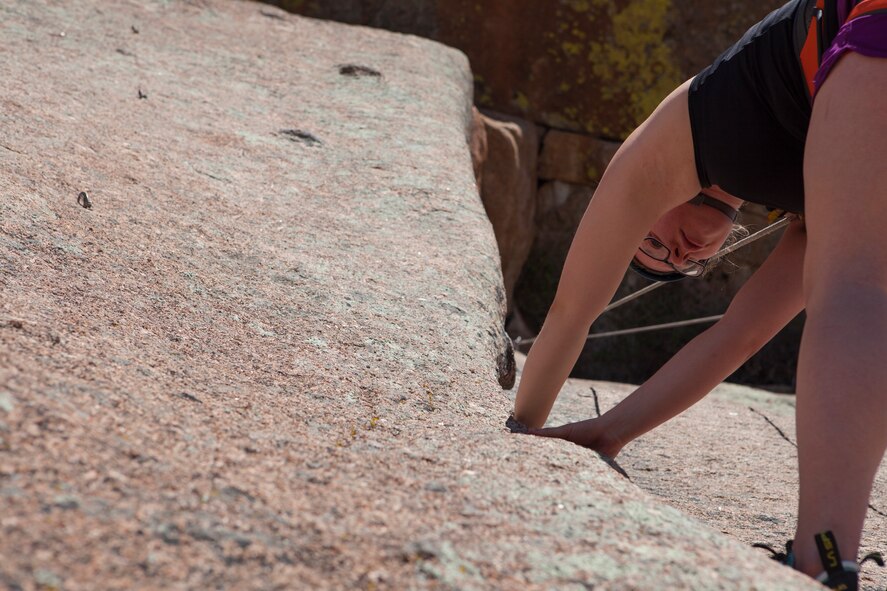 Cheyenne Homkes, a martial arts instructor in Cheyenne, Wyo., climbs the Fall Wall in the Vedauwoo Recreation Area of the Medicine Bow National Forest, June 14, 2015. F.E. Warren Air Force Base’s Outdoor Recreation hosted the rock climbing trip, and they host many other outdoor trips throughout the year. (U.S. Air Force photo by Lan Kim)