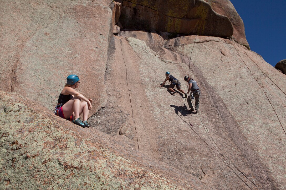 Senior Airman Roman Chavez, 90th Munitions Squadron special weapons technician, F.E. Warren Air Force Base, Wyo., climbs the Fall Wall in the Vedauwoo Recreation Area of Medicine Bow National Forest, June 14, 2015. Fall Wall juts 60 feet in the air, and is a popular rock climbing location. (U.S. Air Force photo by Lan Kim)