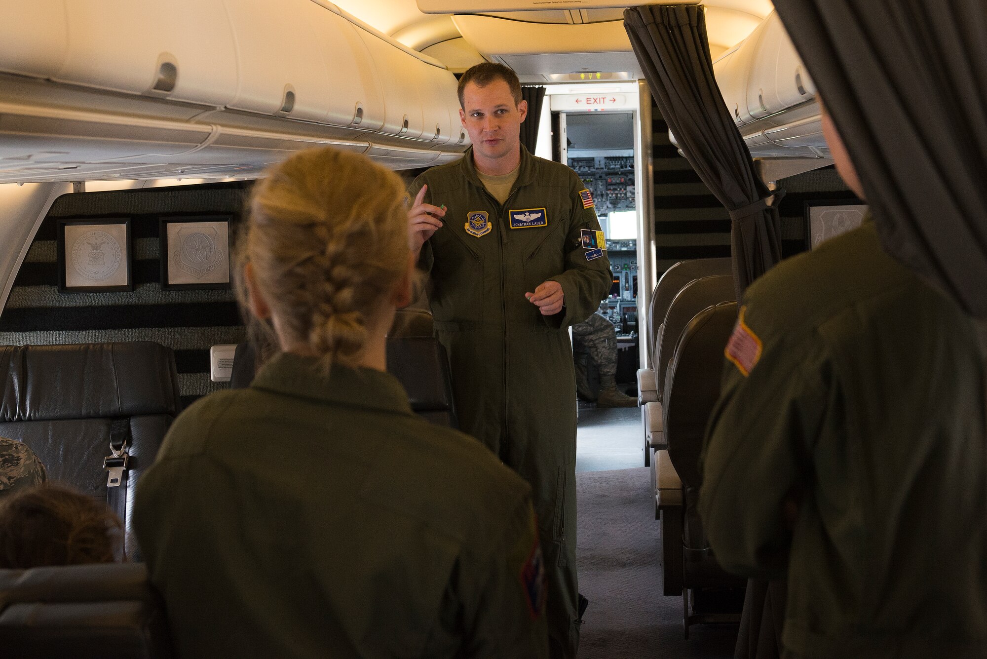 Maj. Jonathan Lauer talks to cadets onboard a C-40 June 8, 2015, flying from Scott Air Force Base, Illinois to the St. Louis, Missouri area. Lauer informed Air Force Academy cadets about the aircraft and answered any of their questions. Lauer is a 54th Airlift Squadron C-40 Pilot. (U.S. Air Force Photo by Airman 1st Class Megan Friedl)