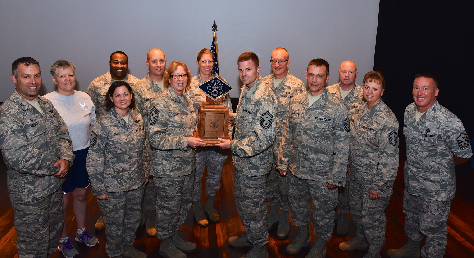 The 932nd Airlift Wing's Command Chief Master Sergeant Vicky Kuntz is at center holding the wing's newest trophy.  She is the Command Chief Master Sergeant assigned to the 932d Airlift Wing, Scott Air Force Base, Illinois. Chief Kuntz leads the enlisted force and advises commanders on matters impacting the enlisted force, such as proper utilization, readiness, professional development, training, and quality of life issues. She ensures the commander's policies are widely publicized and understood by the enlisted force, and serves as the functional manager for all assigned first sergeants. The unit was recently awarded the "2014 Chief Master Sergeant Carol Smits First Sergeant Council of the Year Award" and will maintain it in Illinois until the end of 2015 when a new winner is picked.  (U.S., Air Force photo/Tech. Sgt. Chris Parr)