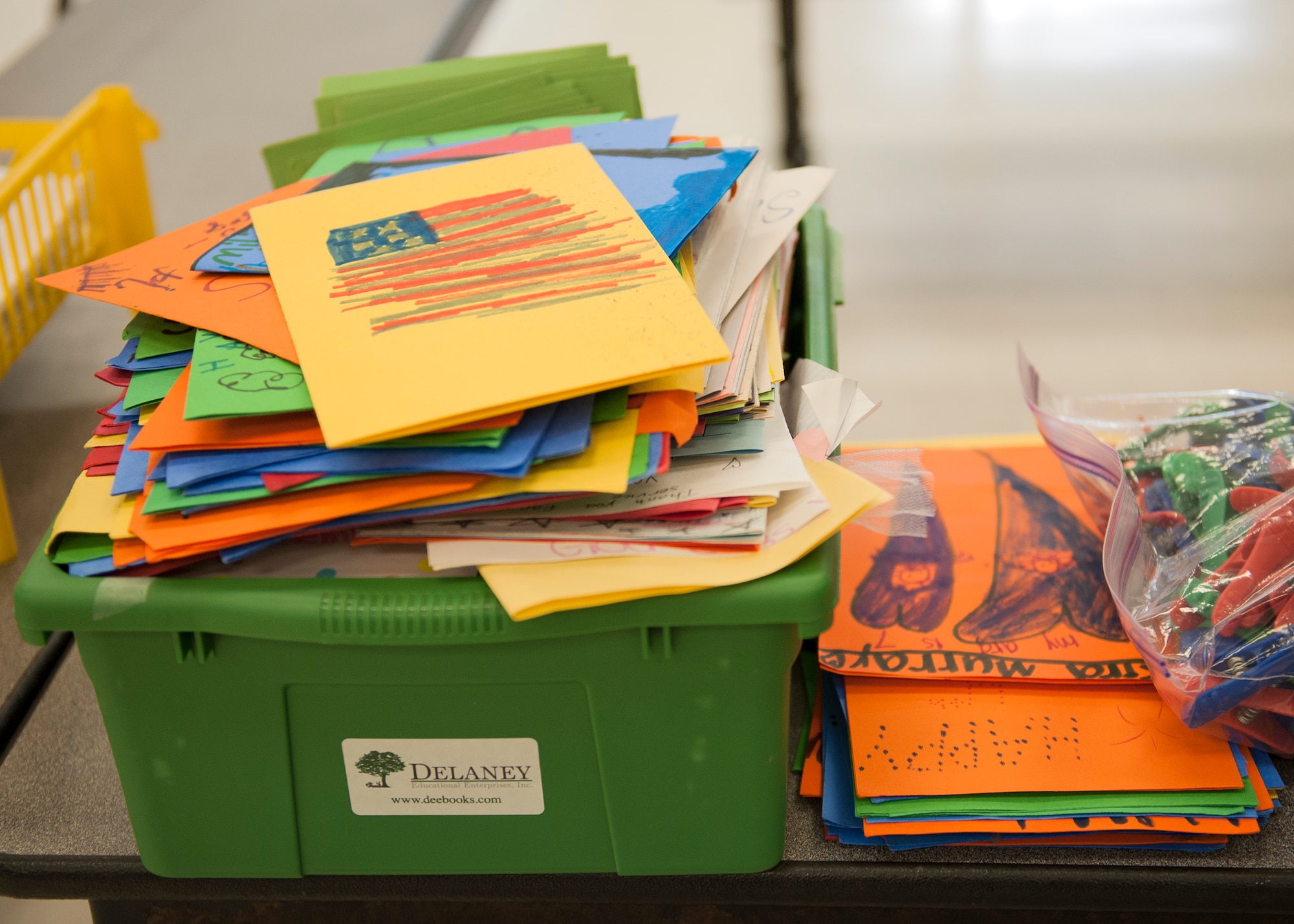 Cards with patriotic appreciation messages sit ready for packages during the Company Grade Officer Council’s troop care drive at the Eglin Elementary School cafeteria June 5 at Eglin Air Force Base, Fla. The CGOC collected cards, letters, drawings and donations from 13 Okaloosa county schools. The boxes were filled with these items along with books, coffee, magazines, snacks and various comfort items for Eglin’s deployed Airmen. Some of the items were donated by the local community through the Airman and Family Readiness Center. Volunteers packed and mailed approximately 60 care packages for Eglin’s deployed. (U.S. Air Force photo/Ilka Cole)