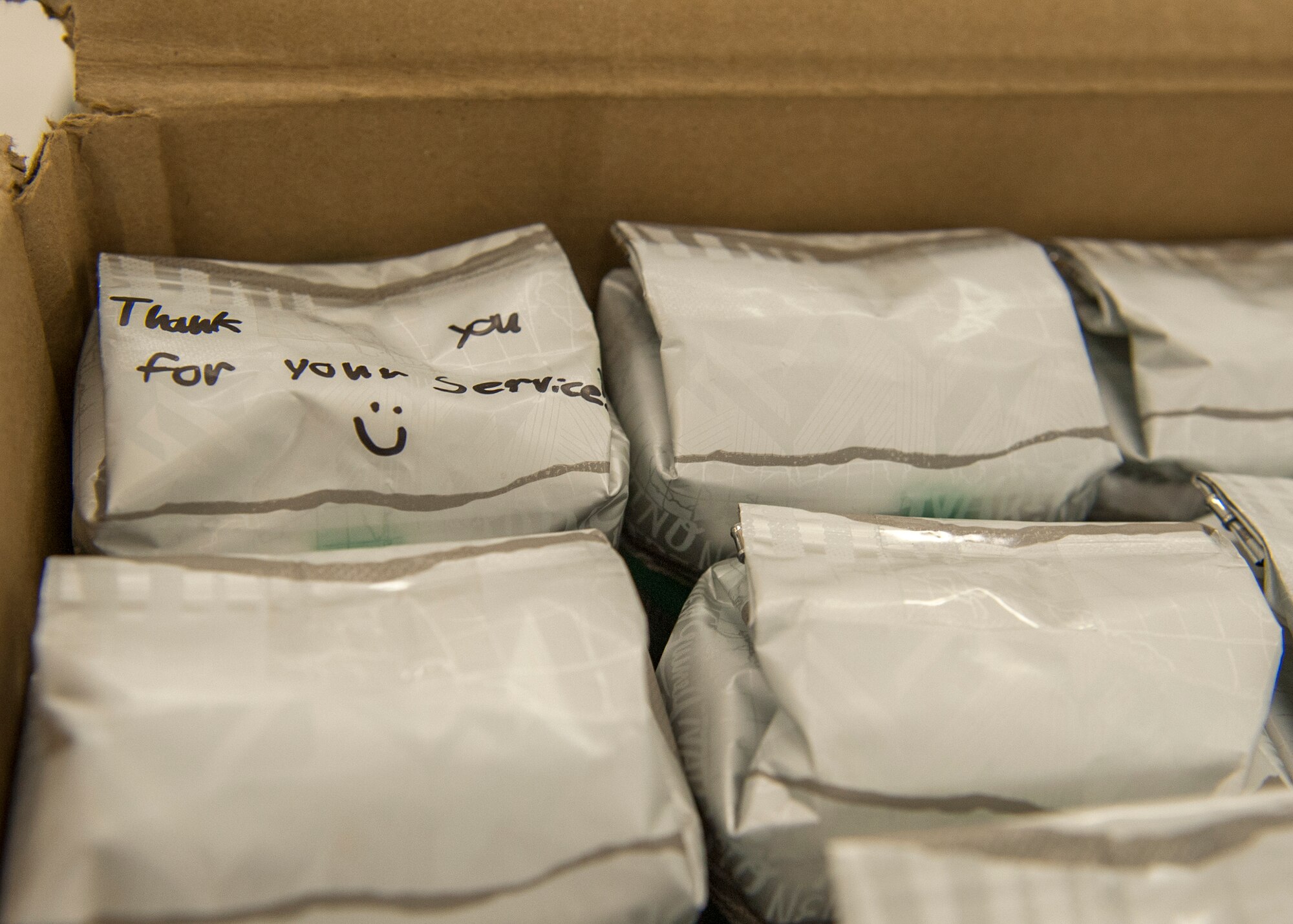 Boxes of coffee donations with handwritten words of appreciation and well wishes were delivered during the Company Grade Officer Council’s troop care drive at the Eglin Elementary School cafeteria June 5 at Eglin Air Force Base, Fla. The CGOC collected cards, letters, drawings and donations from 13 Okaloosa county schools. The boxes were filled with these items along with books, coffee, magazines, snacks and various comfort items for Eglin’s deployed Airmen.  The coffee was donated by the local community through the Airman and Family Readiness Center. Volunteers packed and mailed approximately 60 care packages for Eglin’s deployed. (U.S. Air Force photo/Ilka Cole)