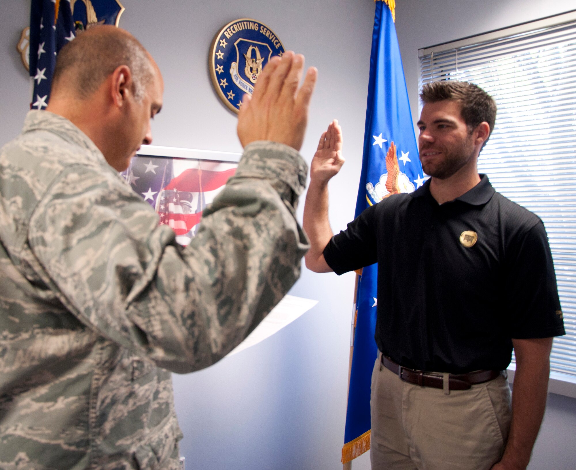 Chaplain (1st Lt.) Karl Heitman (right), from the 446th Airlift Wing, is sworn into office by Chaplain (Lt. Col.) Pierre Allegre, 446th AW chaplain, at the wing recruiting office June 15. Chaplain Heitman, who is also the senior pastor at Carnation Bible Church, is the wing’s newest chaplain. He was commissioned under the Army’s Chaplain Candidate Program in 2011 and completed his master’s degree in divinity in May 2014. (U.S. Air Force Reserve photo by Master Sgt. Minnette Mason)