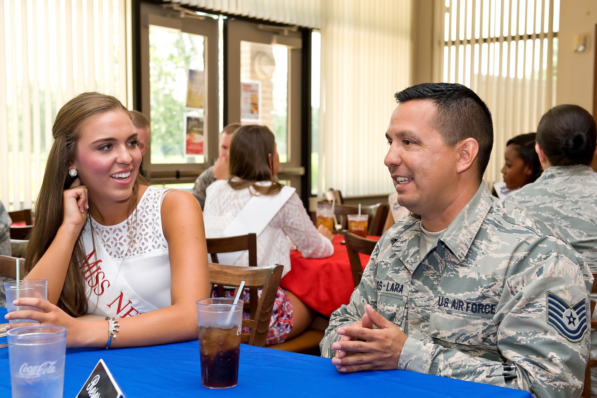 Tech. Sgt. Eduardo Ramos-Lara, 436th Medical Support Squadron medical readiness NCO in charge, talks with Taylor DuVall, Miss Newark, June 11, 2015, at Mulligan?s on Dover Air Force Base, Del. Ramos-Lara and other Team Dover Airmen had lunch with 11 Miss Delaware 2015 contestants as well as the current Miss Delaware, Brittany Lewis, prior to their visit of the base, and touring tours of the C-5 and C-17 aircraft. (U.S. Air Force photo/Roland Balik)