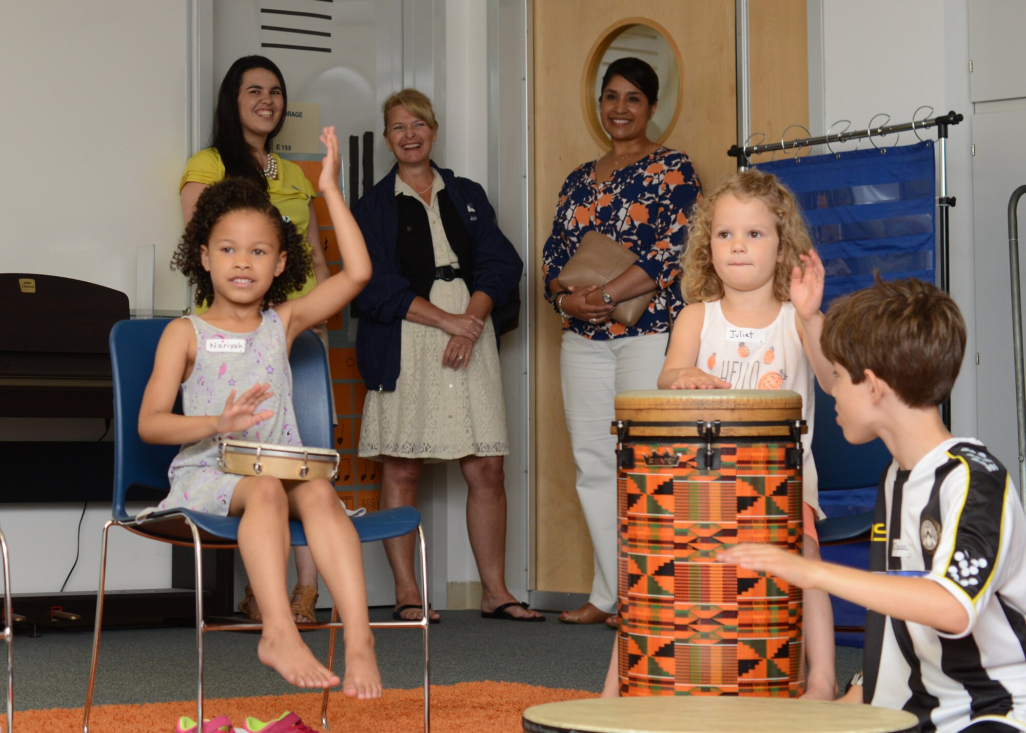 Chief Master Sgt. (ret.) Athena Cody and Stephanie Johnson watches a children’s music camp performance at the Aviano Elementary School, June 16, 2015, at Aviano Air Base, Italy. Cody’s 26 years of service gave her first-hand understanding of the needs and concerns of Air Force families. (U.S. Air Force photo by Senior Airman Austin Harvill/Released)  