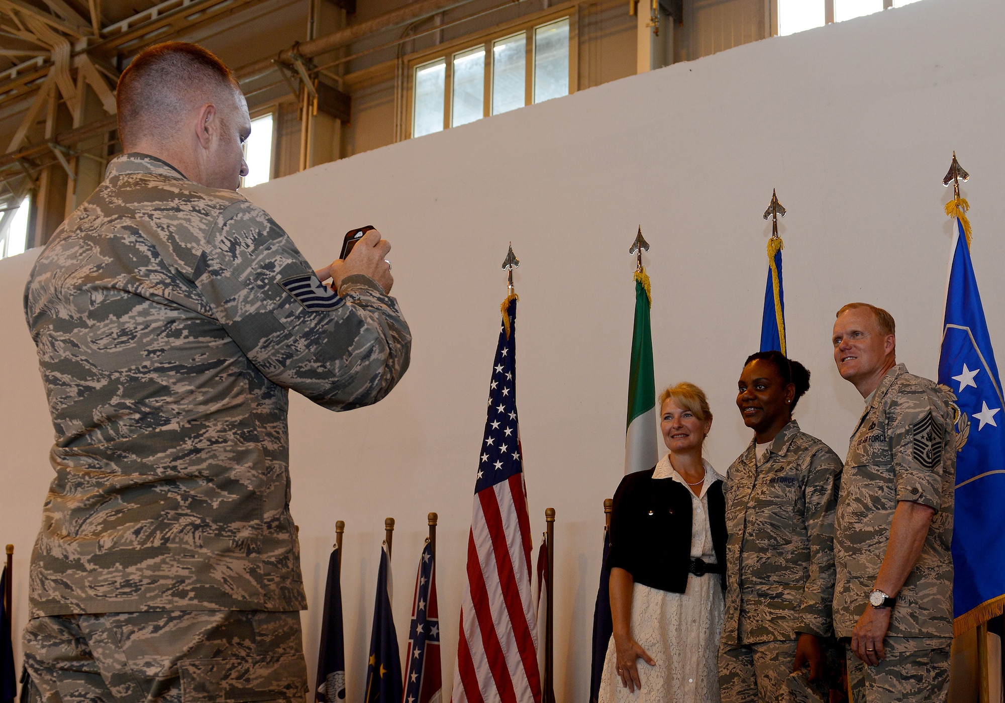 Chief Master Sergeant of the Air Force James A. Cody and his wife, Chief Master Sgt. (ret.) Athena Cody, take a photo with an Aviano Airman, June 16, 2015, at Aviano Air Base, Italy. Cody visited Aviano to thank Airmen and their families for their continued sacrifices, receive feedback on important topics and learn more about Aviano’s mission. (U.S. Air Force photo by Airman 1st Class Deana Heitzman/Released)
