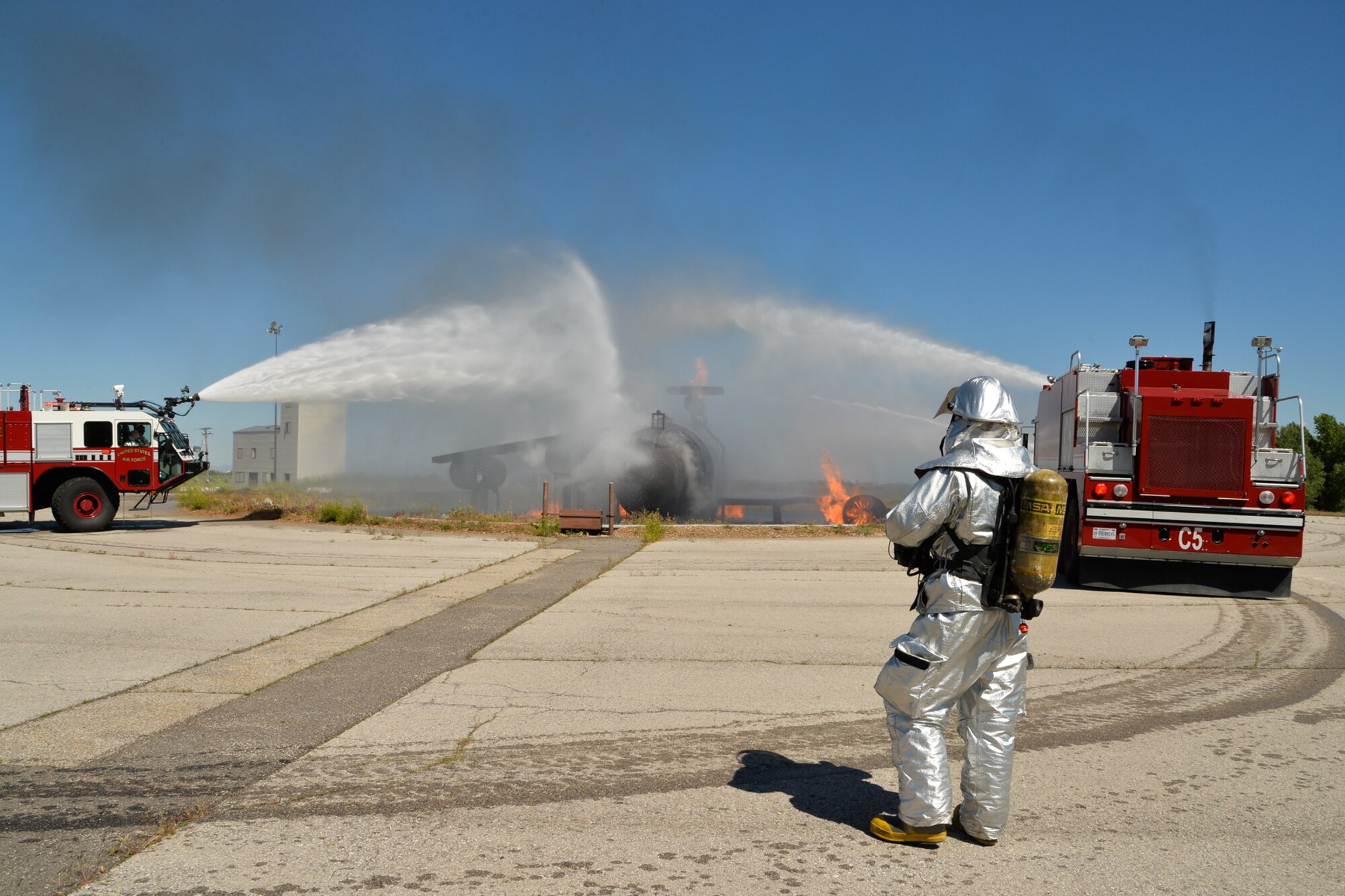 Hill AFB firefighters practice extinguishing a fire on a mock-up of a large-frame aircraft during training recently. Hill Fire and Emergency Services members train constantly to remain proficient in a variety of response roles unique to their Air Force mission. (U.S. Air Force/Ron Bradshaw)