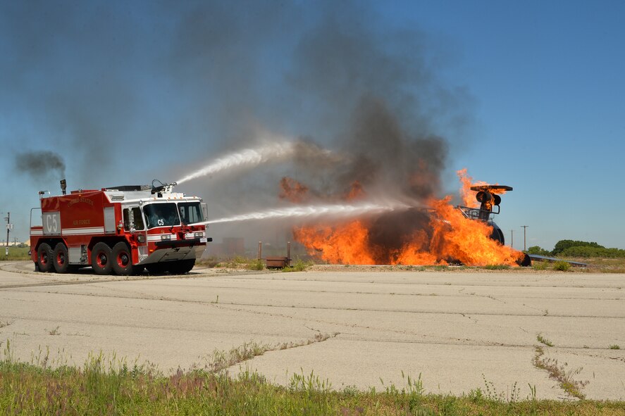 Hill firefighters practice extinguishing an aircraft fire on a mock-up of a large-frame aircraft. The members of Hill Fire and Emergency services train constantly to remain proficient on a variety of response missions. (U.S. Air Force/Ron Bradshaw)