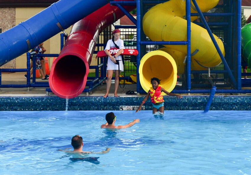 A child slides down a water slide during the annual Pool Bash on Barksdale Air Force Base, La., June 12, 2015. Guests had the option to use four different slides during the event. (U.S. Air Force photo/Airman 1st Class Mozer O. Da Cunha) 