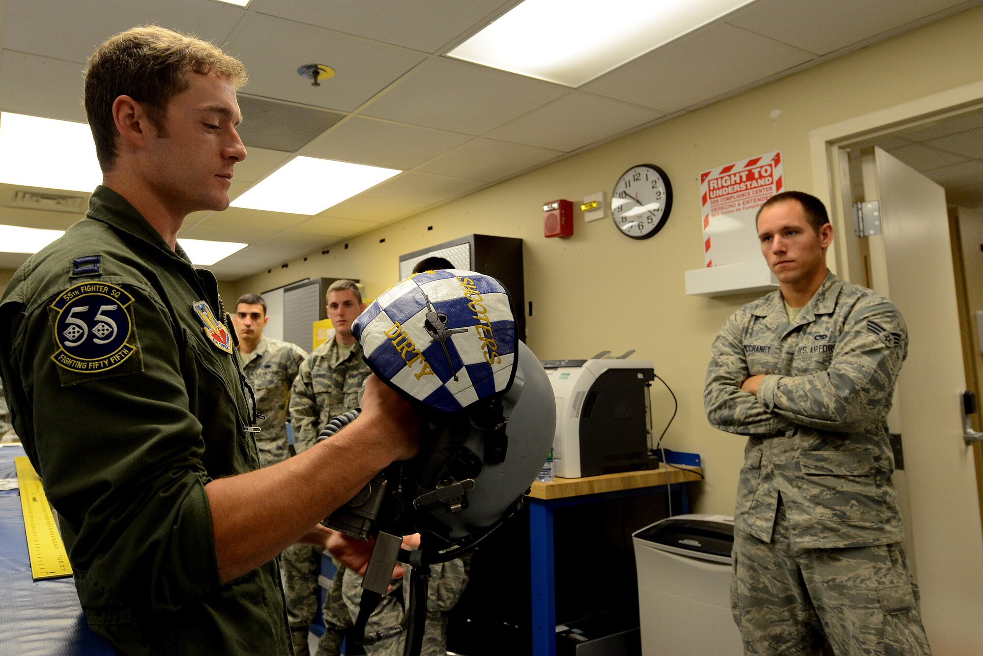 U.S. Air Force Capt. William Baker, 55th Fighter Squadron F-16 flight lead, describes the capabilities of the helmet Team Shaw pilot’s use during the Operations Immersion Program at Shaw Air Force Base, S.C., June 9, 2015. The program was created after leadership saw the benefits of giving Airmen the opportunity to experience the pilot mission on Shaw to demonstrate how their support mission is important to the combat readiness of pilots. (U.S. Air Force photo by Senior Airman Diana M. Cossaboom/Released)