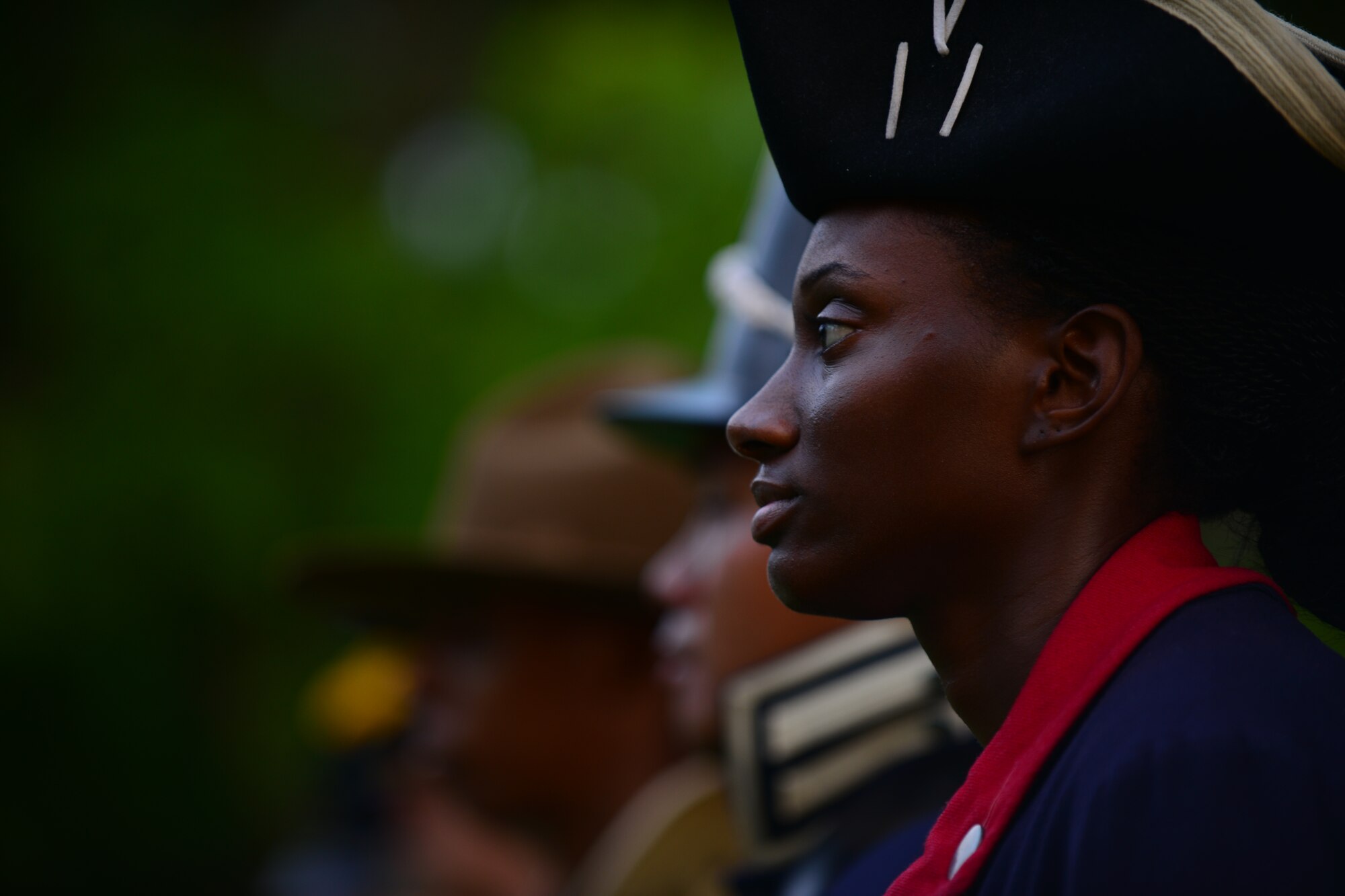 U.S. Army Private 1st Class Delaina Williams, the 359th Inland Cargo Transportation Company, 7th Transportation Brigade (Expeditionary) cargo specialist, participates in the streamers ceremony during an Army Birthday concert and celebration at Fort Eustis, Va., June 12, 2015. Williams participated in the event with fellow Soldiers all of who represented different periods of Army history. (U.S. Air Force photo by Staff Sgt. Natasha Stannard/Released)