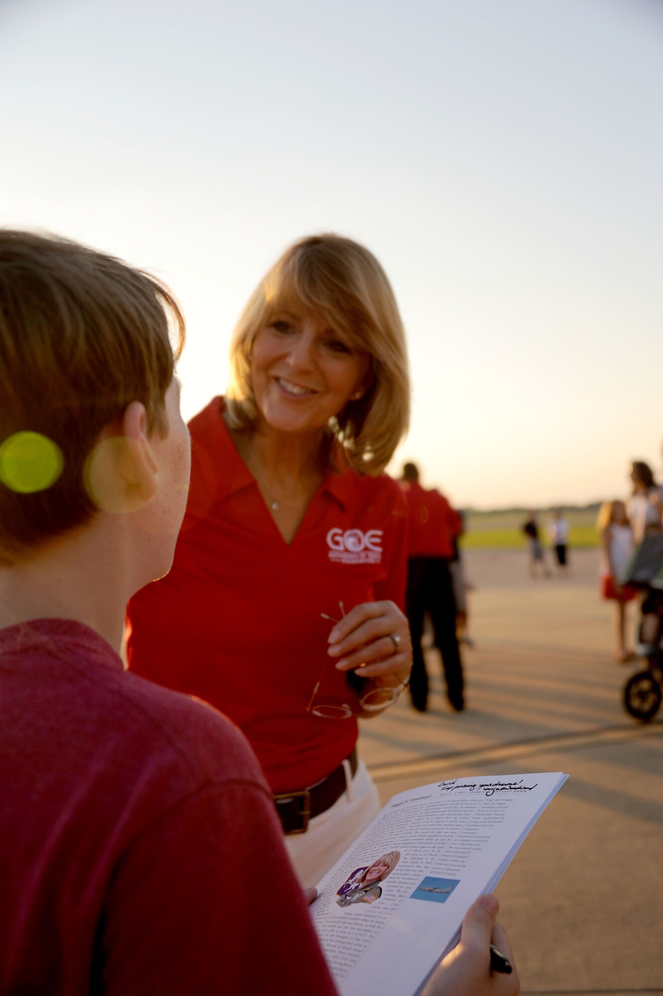 Retired Air Force Maj. Gen. Margaret Woodward, 2015 Gathering of the Eagles honoree, autographs a GOE booklet for a teenager during the GOE and Air Command and Staff College barbeque, June 5, 2015, Maxwell Air Force Base, Alabama. The barbeque gave ACSC students a chance to bring their families to meet GOE honorees and have a close look at Air Force aircraft. (U.S. Air Force photo by Airman 1st Class Alexa Culbert)