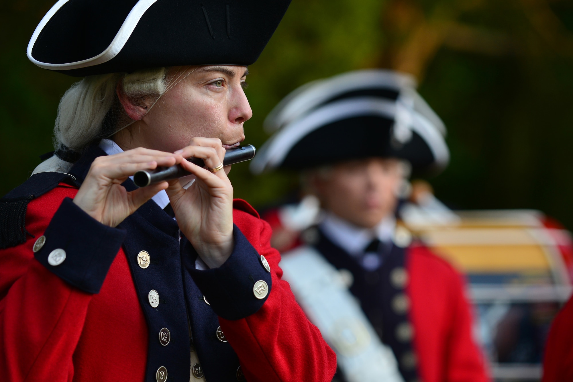 Members of the 3rd U.S. Infantry Regiment (Old Guard) Fife and Drum Corps perform during the 240th Army Birthday concert and streamer ceremony at Fort Eustis, Va., June 12, 2015. The ceremony also featured performances by the Training and Doctrine Command Band concert and rock bands, a streamer ceremony showcasing the U.S. Army’s accomplishments and an enlistment ceremony for future Soldiers. (U.S. Air Force photo by Staff Sgt. Natasha Stannard/Released)