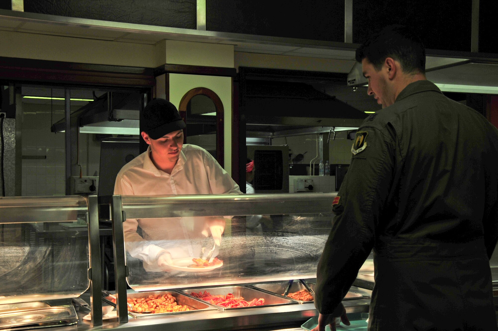Jake Symons, a staff member at the dining facility, serves breakfast to a member of the 23rd Expeditionary Bomb Squadron forward deployed to Royal Air Force Fairford, England, June 14, 2015 in support of BALTOPS 15 and Saber Strike 15. The base was transitioned from a “warm” status to an active status to support over 200 personnel forward deployed to participate in the exercises. The purpose of the multi-national exercises is to promote mutual understanding, confidence, cooperation and interoperability among forces and personnel of participating nations.  (U.S. Air Force photo/Senior Airman Malia Jenkins) 
