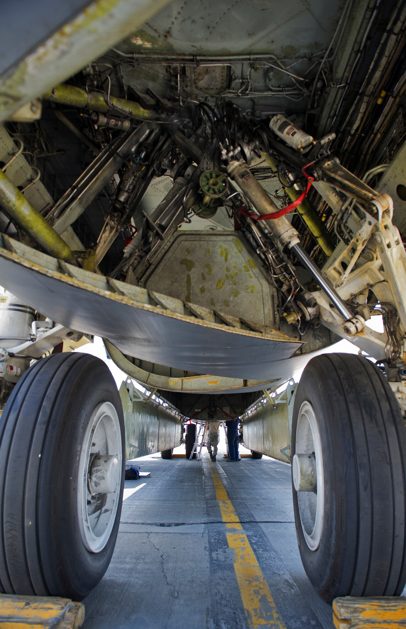 Airmen from the 5th Aircraft Maintenance Squadron perform maintenance underneath a B-52H Stratofortress at Minot Air Force Base, N.D., June 11, 2015. The B-52H can perform strategic attack, close-air support, air interdiction, offensive counter-air and maritime operations. (U.S. Air Force photo/Airman 1st Class Justin T. Armstrong)