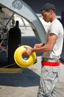 Airman 1st Class Lloyd Haynes, 5th Aircraft Maintenance Squadron crew chief, winds electrical cable after performing routine maintenance on a B-52H Stratofortress at Minot Air Force Base, N.D., June 11, 2015.  For more than 40 years, B-52H Stratofortresses have been the backbone of the manned strategic bomber force for the United States. (U.S. Air Force photo/Airman 1st Class Justin T. Armstrong)