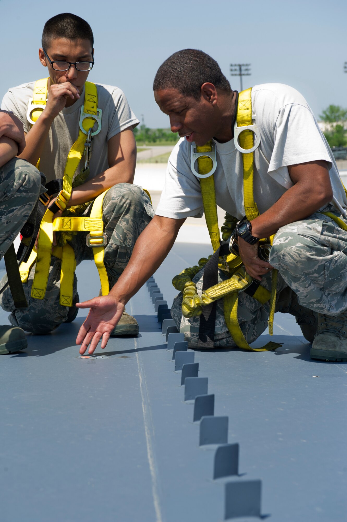An instructor from the 5th Aircraft Maintenance Squadron trains Airmen on the wing of a B-52H Stratofortress at Minot Air Force Base, N.D., June 11, 2015. The B-52H can perform strategic attack, close-air support, air interdiction, offensive counter-air and maritime operations. (U.S. Air Force photo/Airman 1st Class Justin T. Armstrong)