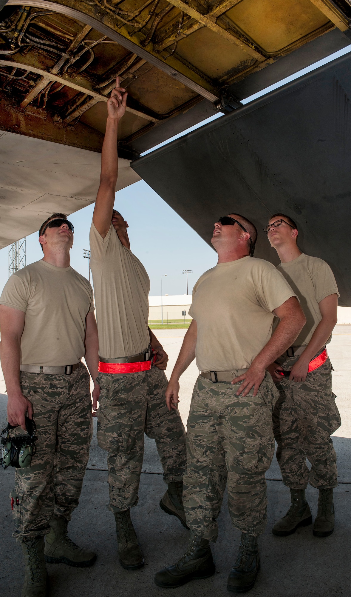 Airmen from the 5th Aircraft Maintenance Squadron discuss maintenance procedures for a B-52H Stratofortress with an instructor at Minot Air Force Base, N.D., June 11, 2015. The Airmen received on-the-job training which served as a way for instructors to show their Airmen the proper procedures for maintaining the B-52H. (U.S. Air Force photo/Senior Airman Stephanie Morris)