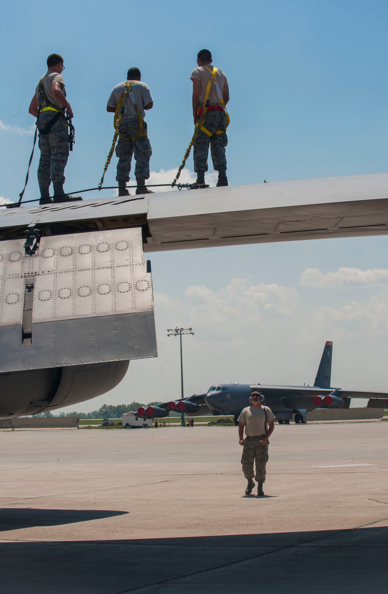 Airmen from the 5th Aircraft Maintenance Squadron receive instructions while standing on the wing of a B-52H Stratofortress at Minot Air Force Base, N.D., June 11, 2015. The training served as a way for instructors to show Airmen proper procedures for maintaining the B-52H. (U.S. Air Force photo/Senior Airman Stephanie Morris)