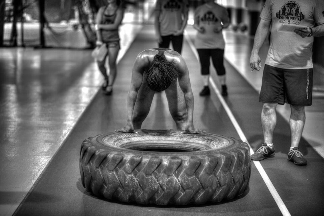 Demetria, or “Mimi,” a U. S. Air Force Senior Airman from the 20th Intelligence Squadron, pauses from doing tire flips during the 2015 Team Offutt Tactical Fitness games June 12 at Offutt Air Force Base, Nebraska. Mimi finished in 2nd Place of the Scaled Women's Division. Nearly 50 athletes from Offutt AFB and the greater Omaha area participated in the event that has been held annually at Offutt since 2013. (Courtesy photo)