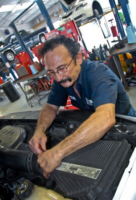 Jim Lufrano, an Auto Hobby Shop mechanic, checks a car’s air filter at Eglin Air Force Base, Fla., June 5.  The Auto Hobby Shop also does full-service and minor car repairs, tune-ups and is a do-it-yourself area for mechanics. (U.S. Air Force photo/Kevin Gaddie)
  
