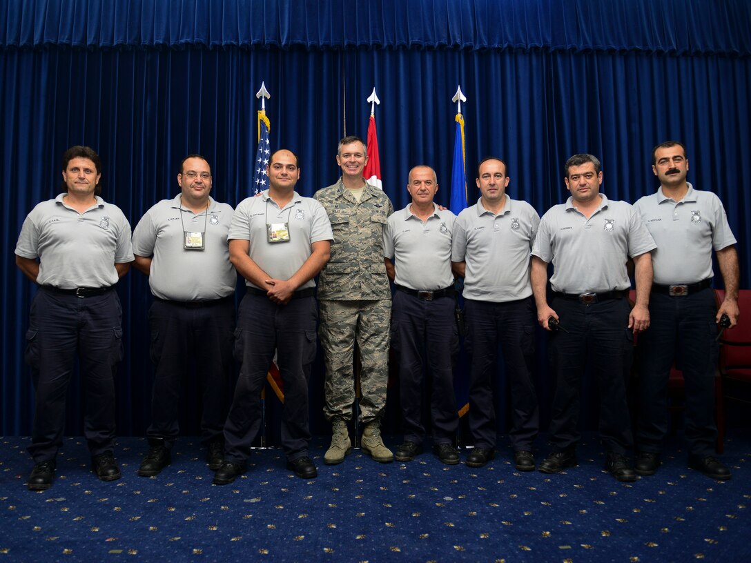 Col. Craig Wills, 39th Air Base Wing commander, and firefighters from the 39th Civil Engineer Squadron Incirlik Fire Emergency Services pose for a picture during a Turkish employee appreciation reception at the Club Complex June 9, 2015, at Incirlik Air Base, Turkey. The reception was the first of its kind with more than 300 U.S. and Turkish service members in attendance. (U.S. Air Force photo by Staff Sgt. Eboni Reams/Released)