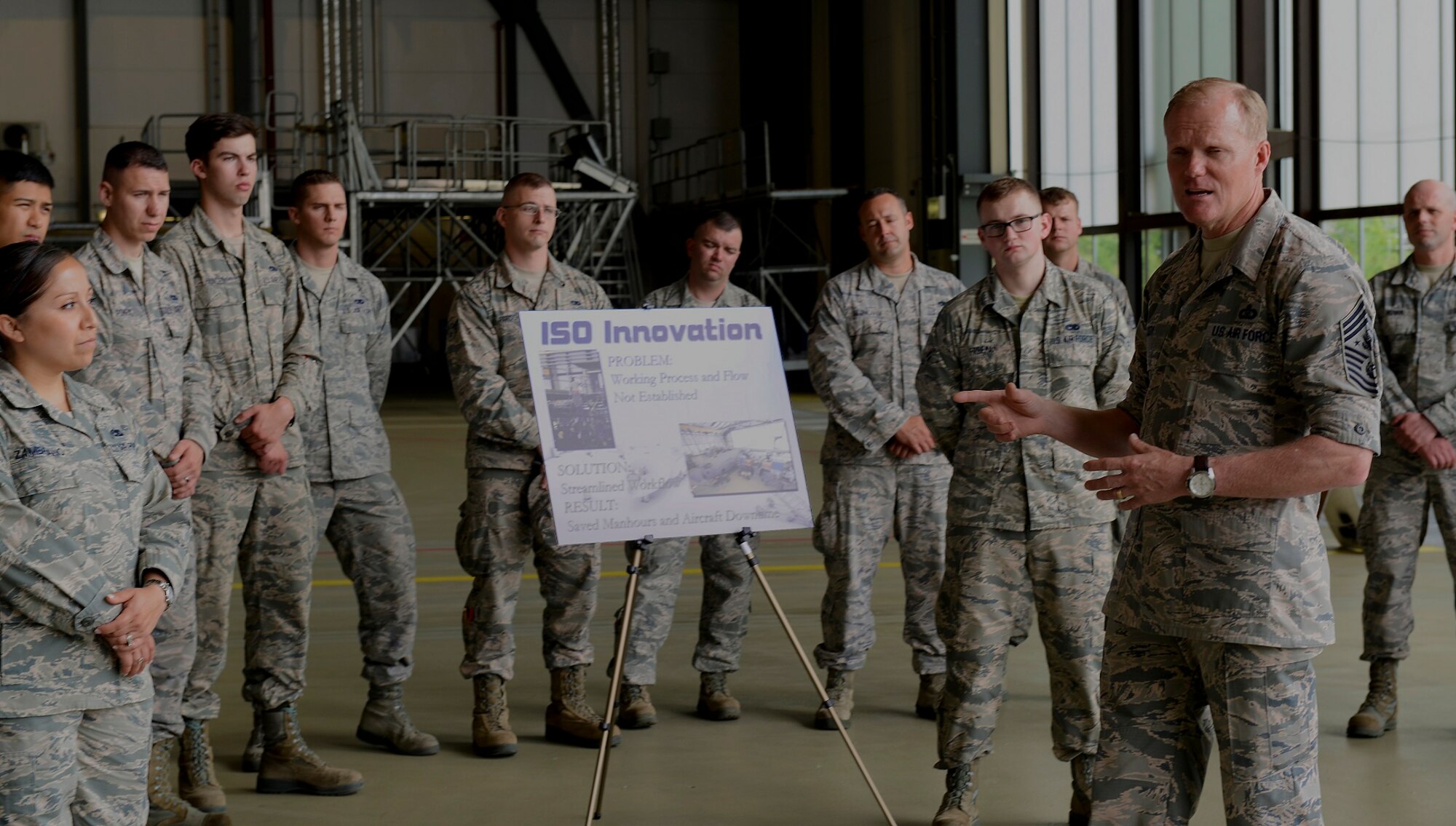 Chief Master Sergeant of the Air Force James A. Cody speaks with Airmen from the 86th Aircraft Maintenance Squadron during a tour of Ramstein Air Base, Germany June 15, 2015. Before the tour, Cody asked each squadron he was going to visit to select an Airman they believed went above and beyond their duties, and he presented those individuals with a coin. (U.S. Air Force photo/Airman 1st Class Tryphena Mayhugh)