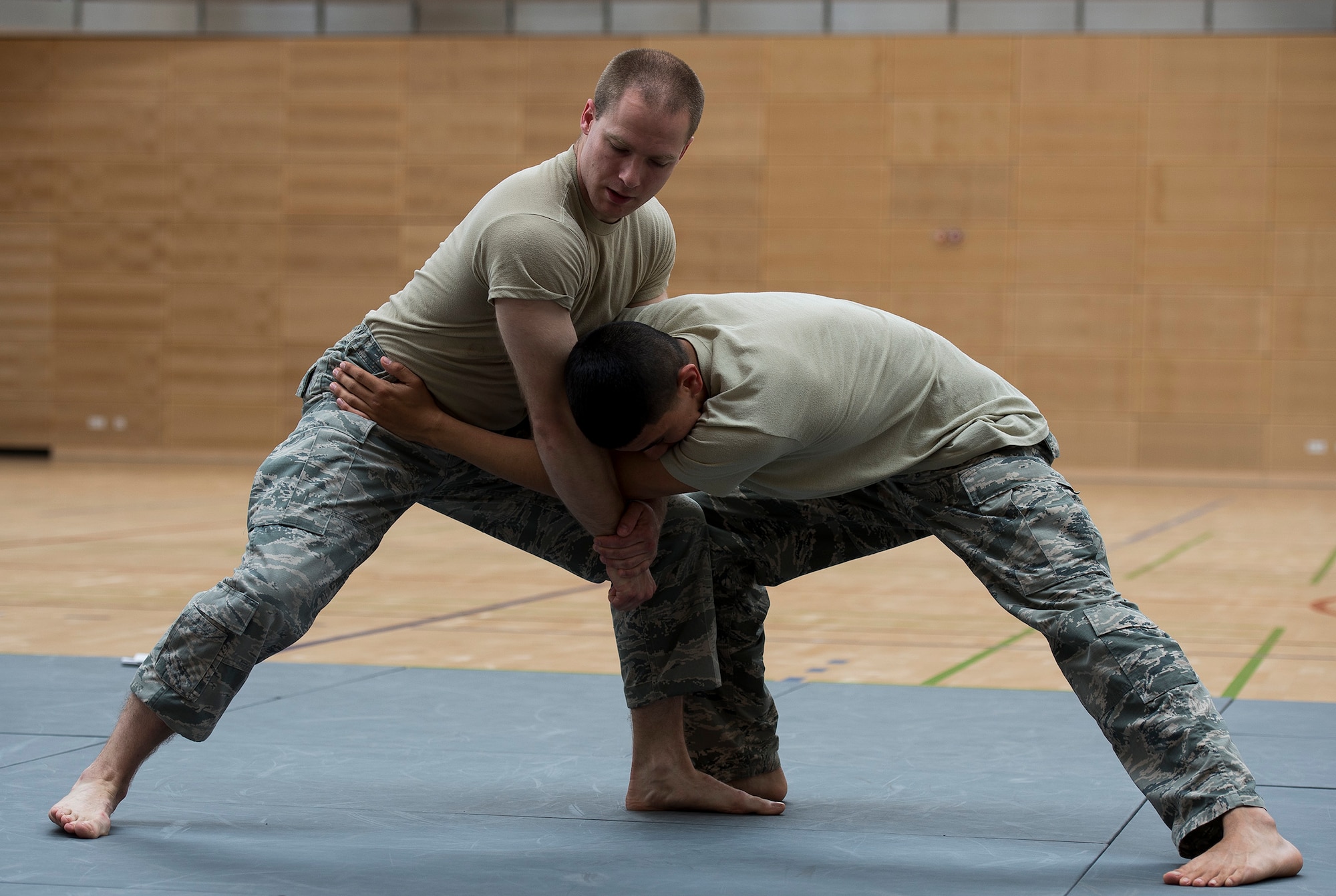 U.S. Air Force Senior Airman Erik Alter, 52nd Security Forces Squadron lead combatives instructor, demonstrates a technique to Airmen from the 52nd SFS during combatives training May 28, 2015 at the fitness center on Spangdahlem Air Base, Germany. Military law enforcement officers conduct regular hand-to-hand combat training to ensure they are prepared for any hostile suspects they might encounter. (U.S. Air Force photo by Staff Sgt. Chad Warren/Released)