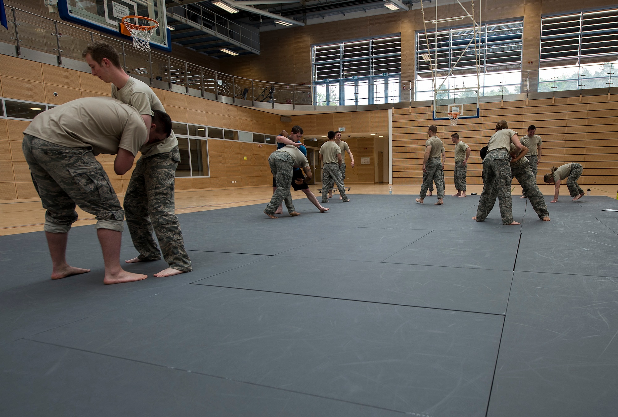 U.S. Air Force Airmen from the 52nd Security Forces Squadron undergo combatives training May 28, 2015 at the fitness center on Spangdahlem Air Base, Germany. Military law enforcement officers conduct regular hand-to-hand combat training to ensure they are prepared for any hostile suspects they might encounter. (U.S. Air Force photo by Staff Sgt. Chad Warren/Released)