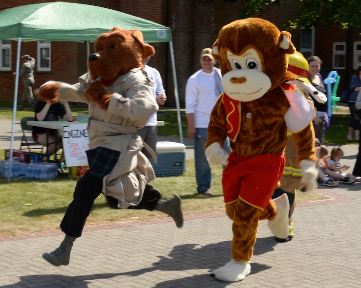 Team Mildenhall mascots race during the Marauder Melee June 11, 2015, on RAF Mildenhall, England. Events included a petting zoo, multiple bouncy attractions, Segway rides, cart racing, and a race between mascots including Sparky the Fire Dog and Max the Monkey. (U.S. Air Force photo by Gina Randall/Released)