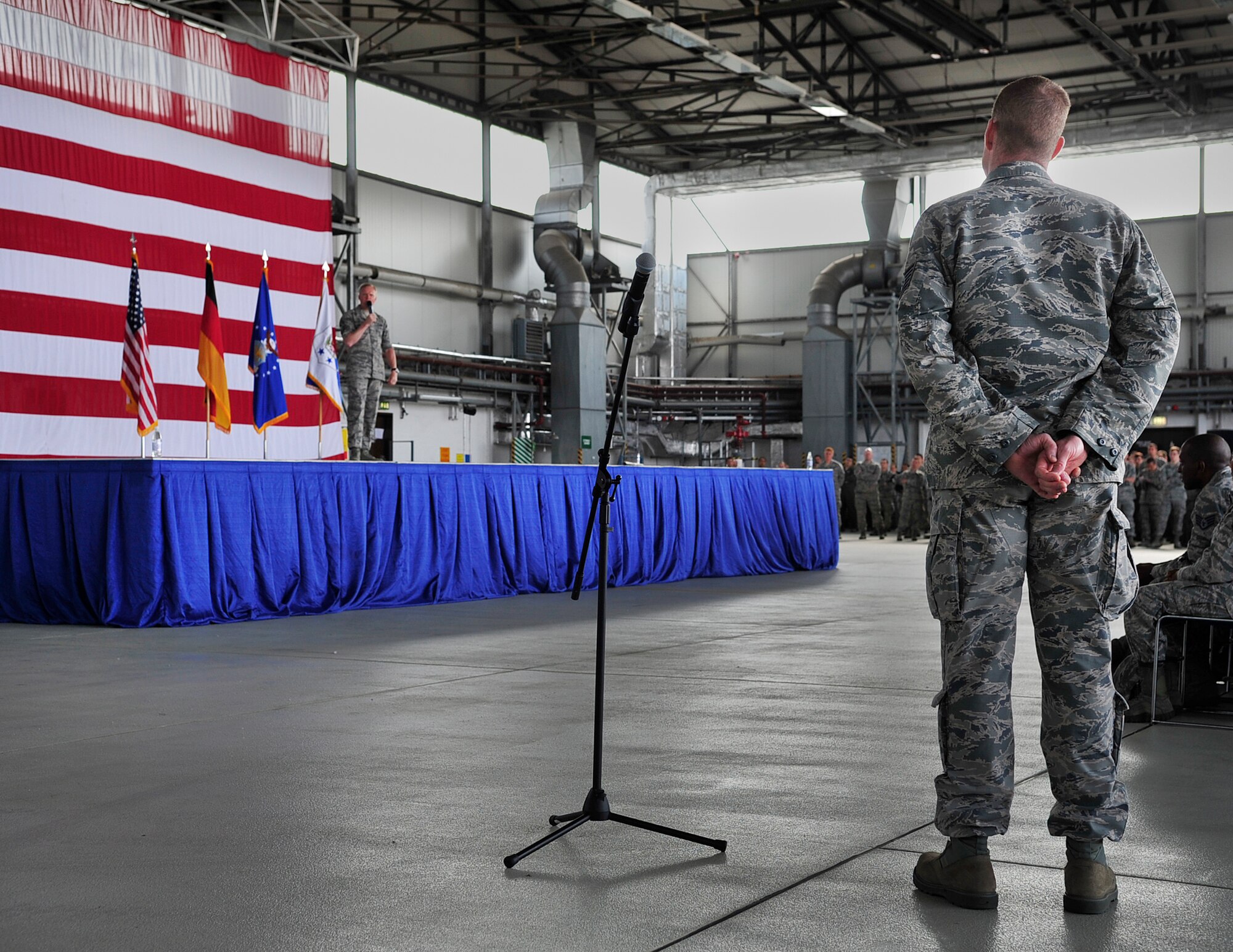 An Airman asks Chief Master Sgt. of the Air Force James A. Cody a question during an all-call June 15, 2015, at Ramstein Air Base, Germany. Airmen had the opportunity to ask Cody questions regarding their concerns of future Air Force processes. (U.S. Air Force photo/Airman 1st Class Larissa Greatwood)