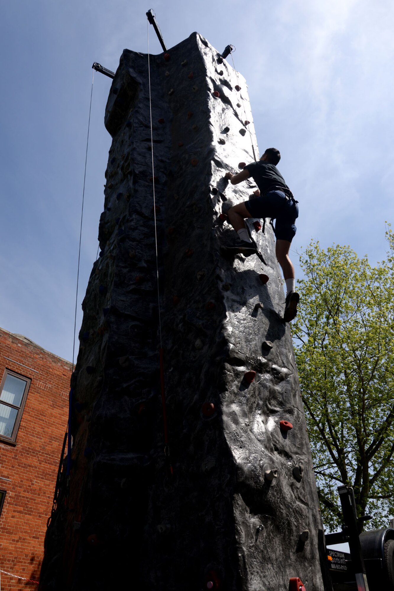 U.S. Air Force 2nd Lt. Michael Joo, 100th Air Refueling Wing protocol officer from Houston, Texas, climbs a rock wall at the Marauder Melee June 11, 2015, on RAF Mildenhall, England. After a 5k run, groups and squadrons across the base participated in a variety of fitness challenges in hopes of winning this year’s Marauder Melee sports competition. (U.S. Air Force photo by Senior Airman Kate Thornton/Released)
