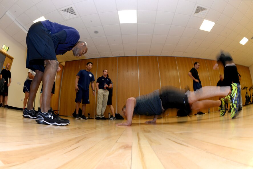 U.S. Air Force firefighters from the 100th Civil Engineer Squadron, complete the Mad Marauder Challenge during the Marauder Melee June 11, 2015, on RAF Mildenhall, England. The challenge consisted of teams of four people performing as many pushups, situps and burpees in four minutes, four times with only three-minute breaks in between, and was one of the many events making up the all-day sports competition amongst groups and squadrons across base. (U.S. Air Force photo by Senior Airman Kate Thornton/Released)