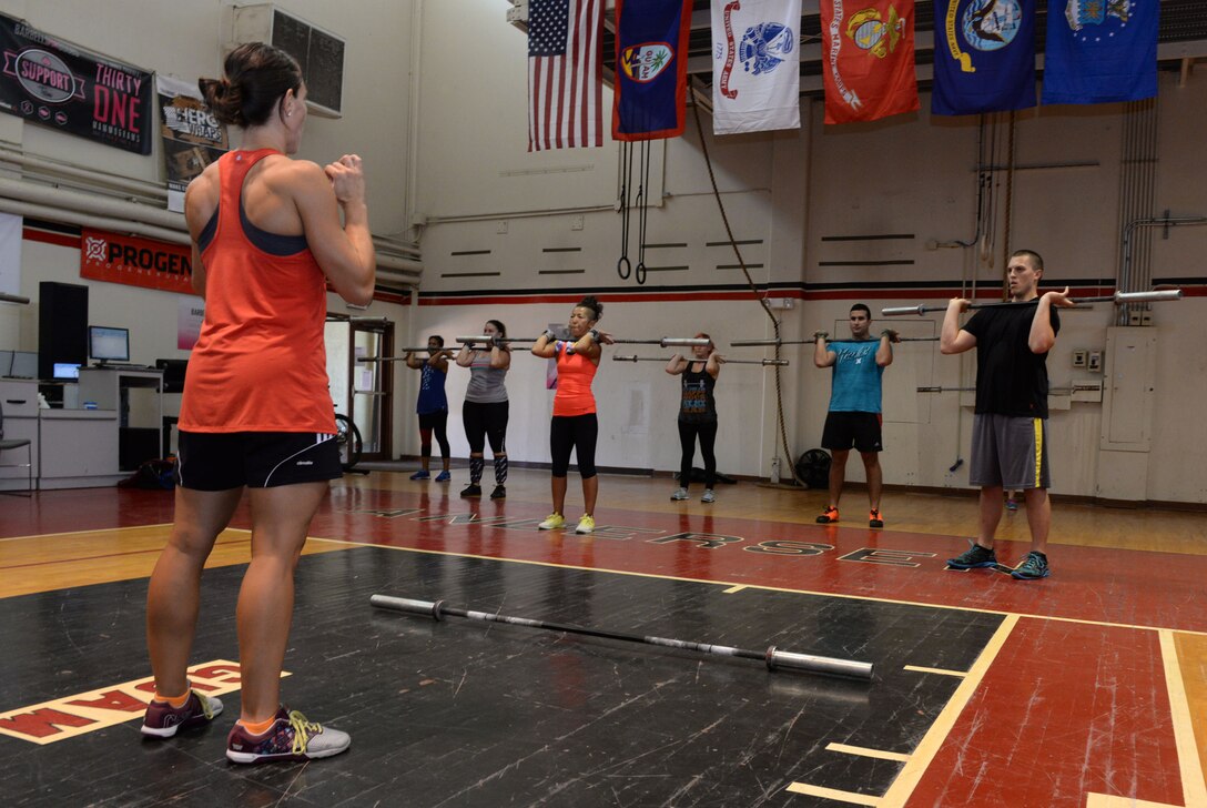 Team Andersen members learn how to execute a clean using proper form June 15, 2015, at the functional fitness gym on Andersen Air Force Base, Guam. CrossFit-certified trainers continue to keep an eye on gym members to track progress, make sure they’re doing the movements correctly and make sure they are comfortable performing the exercises. (U.S. Air Force photo by Airman 1st Class Joshua Smoot/Released)