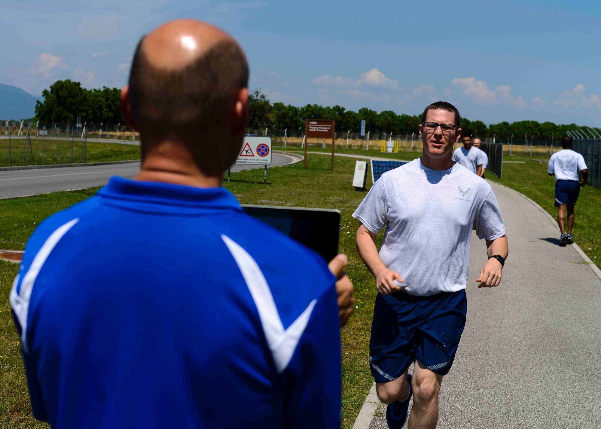From left, Kevin Egger, Health Promotion coordinator analyzes the gait of U.S. Air Force Staff Sgt. Blake Casagrande, 31 Civil Engineer Squadron preventive maintenance supervisor, during a running clinic June 8, 2015, at Aviano Air Base, Italy. Running clinics are one option available to improve Airmen’s running form, and Airmen can contact their unit fitness managers for more information. (U.S. Air Force photo by Senior Airman Austin Harvill/Released)