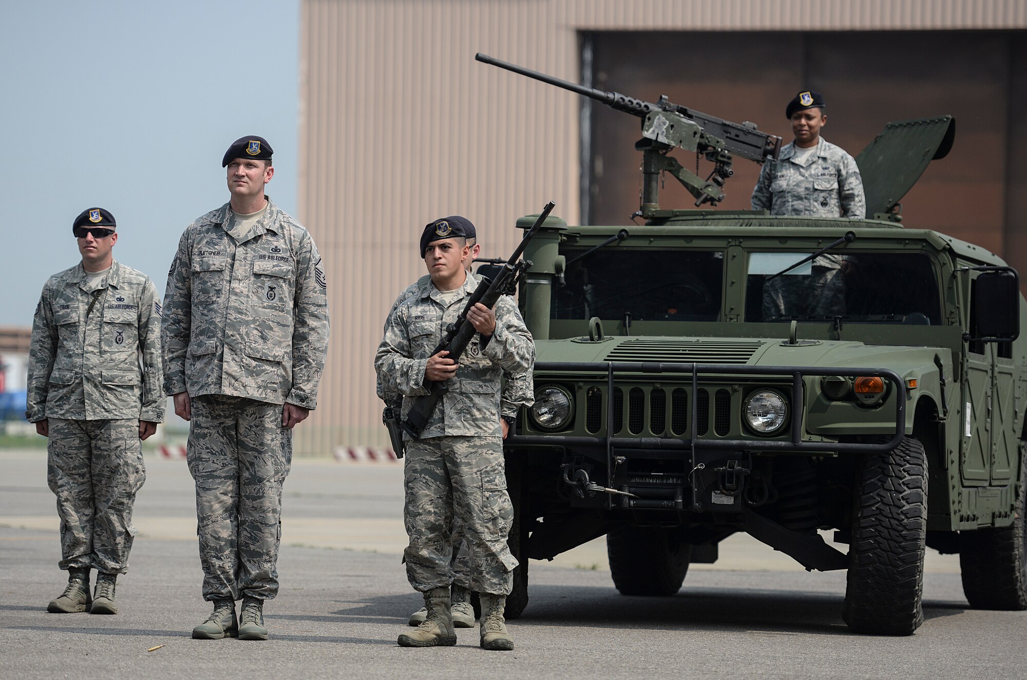 Senior Airman Rogelio Rios, 51st Security Forces Squadron member, fires two shots from a rifle during the 51st Fighter Wing Change of Command Ceremony, June 16, 2015, at Osan Air Base, Republic of Korea. The first shot was fired simultaneously with the outgoing commander passing off the guide on, releaving his command and the second shot as the guide on was passed to the incoming commander. (U.S. Air Force photo by Senior Airman Matthew Lancaster)