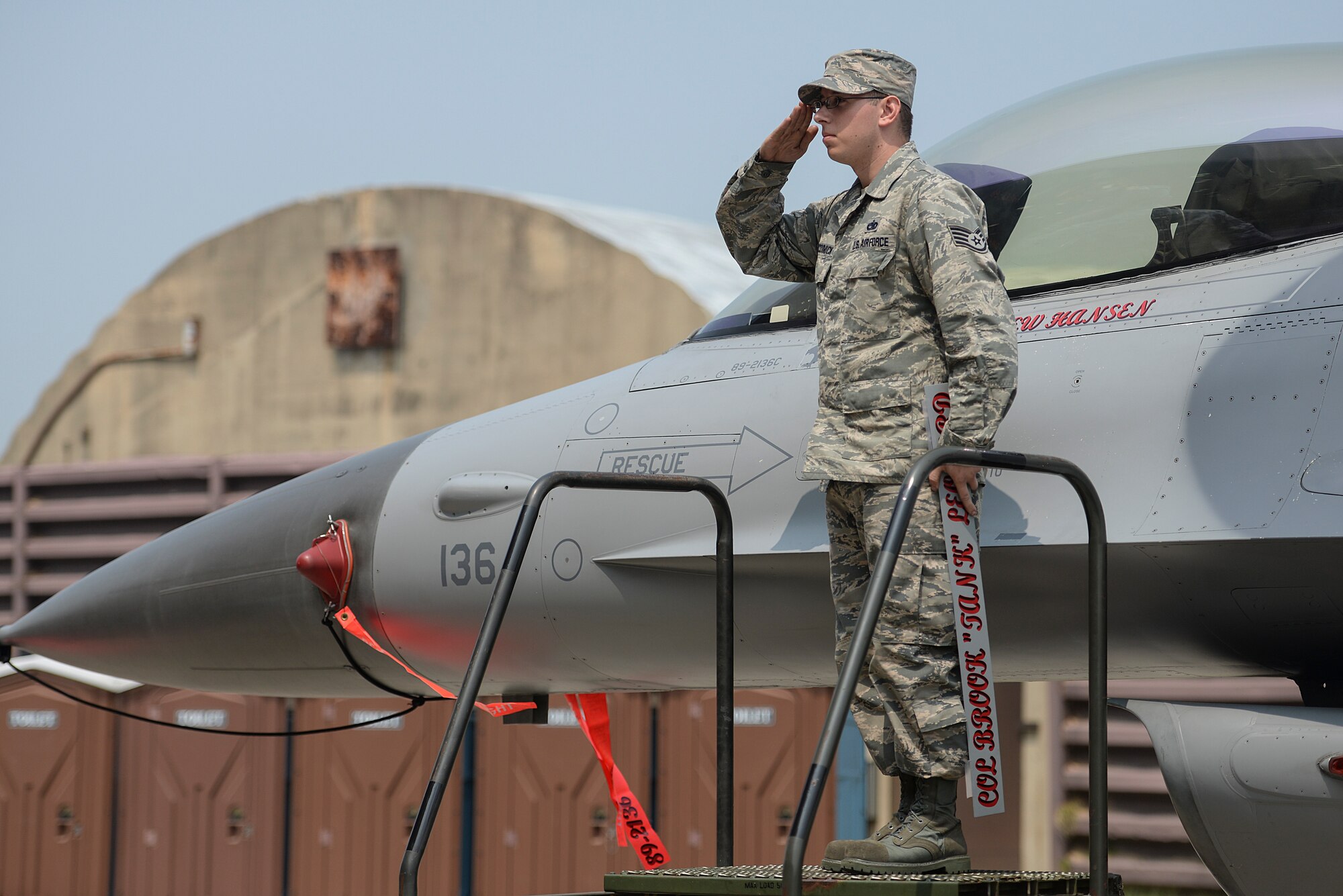 Staff Sgt. Patrick McCormick, 51st Aircraft Maintenance Squadron dedicated crew chief, salutes the new 51st Fighter Wing commander during the 51st FW Change of Command ceremony, June 16, 2015, at Osan Air Base, Republic of Korea. The Change of Command ceremony is a military tradition that represents a formal transfer of authority and responsibility for a unit from one commanding officer to another. (U.S. Air Force photo by Senior Airman Matthew Lancaster)