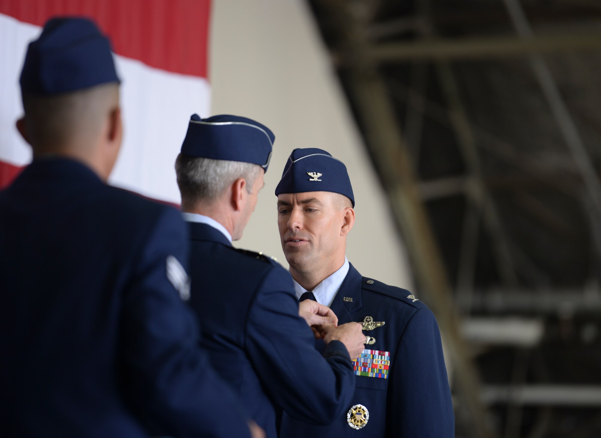 Lt. Gen. Terrence  O'Shaughnessy, 7th Air Force commander, pins on the Legion of Merit onto Col. Brook Leonard, 51st Fighter Wing commander, during the 51st FW Change of Command Ceremony, June 16, 2015, at Osan Air Base, Republic of Korea. During a Change of Command ceremony, the passing of colors, standards, or ensigns from an outgoing commander to an incoming one ensures that the unit and its soldiers is never without official leadership, a continuation of trust, and also signifies an allegiance of soldiers to their unit's commander.(U.S. Air Force photo by Senior Airman Matthew Lancaster)