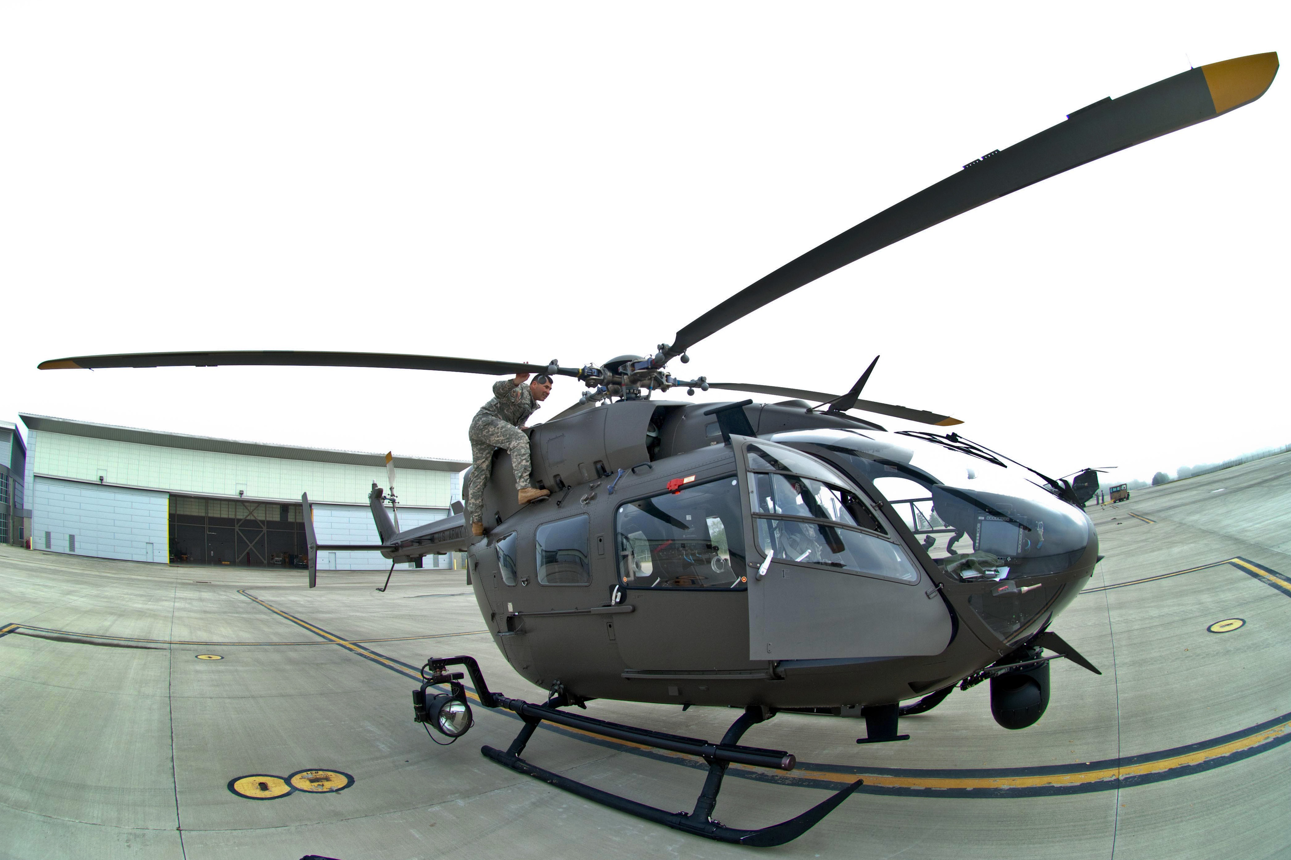 Army Cpt. Chris Jones checks the main rotor blades as he performs a pre ...